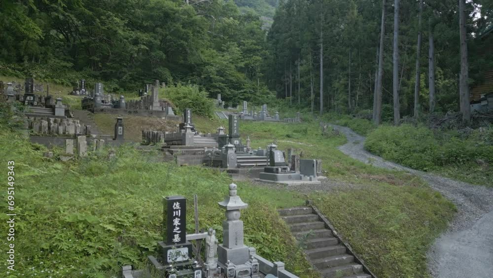 Establishing shot of an old cemetery in Japan, showing gravestones on a mountain side. Establishing shot of an old cemetery in Japan, showing gravestones on a mountain side.