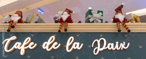 Cuadro en lienzo Christmas decoration with wording of 'CAFE DE LA PAIX', Santa Claus, and giftbox at Crescent Mall, Ho Chi Minh city, Vietnam
