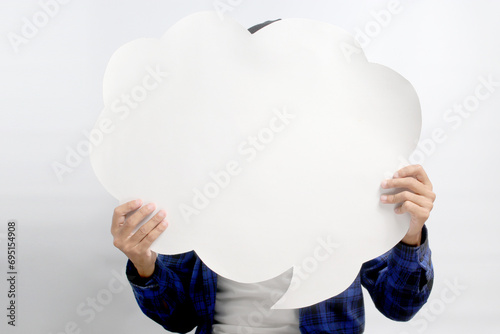 Fotografia Asian man, concealing his face behind a speech bubble held in front of him, stan