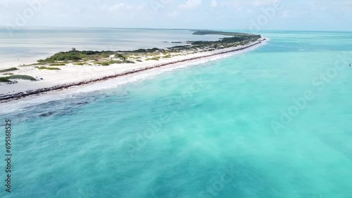 Aerial of Isla Blanca, Mexico, view of picturesque scene where waves gently crash onto the pristine white sand beach. Long thin peninsula located 20km north of downtown Cancún. photo