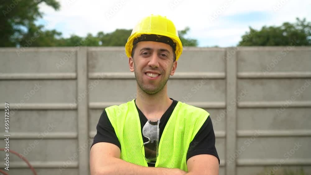 A Construction Worker Wearing a Yellow Hard Hat Appears Content with the Outcome of His Labor - Medium Close Up A Construction Worker Wearing a Yellow Hard Hat Appears Content with the Outcome of His Labor - Medium Close Up