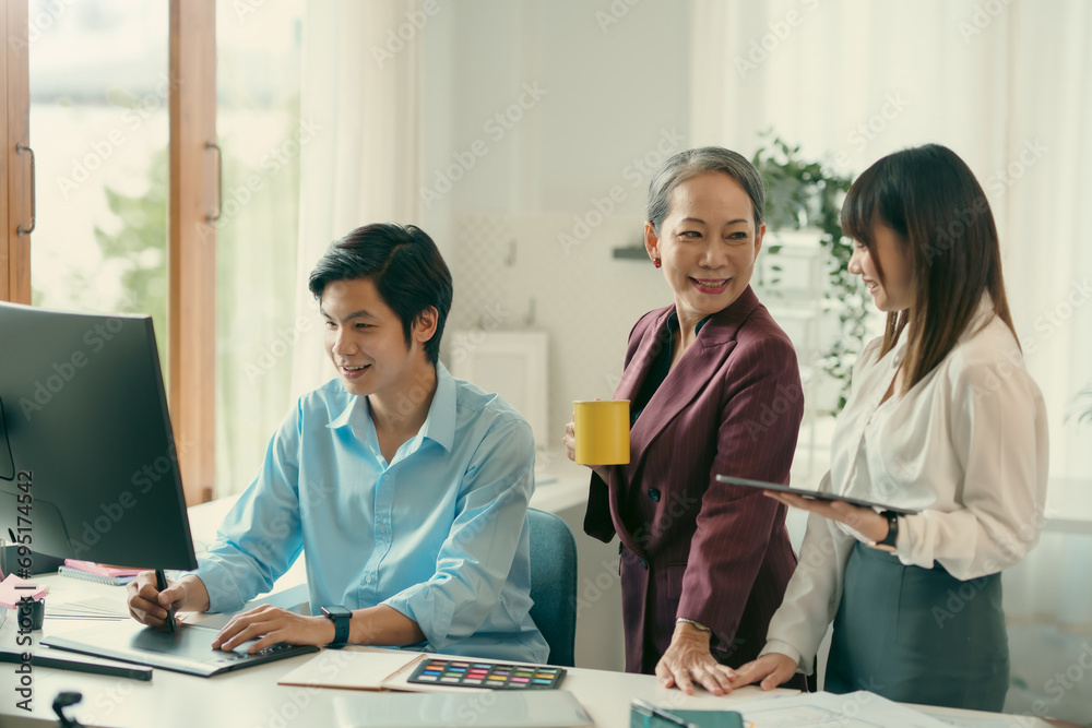 Group of asian designer talking and development ux app on mobile phone during the meeting in office.