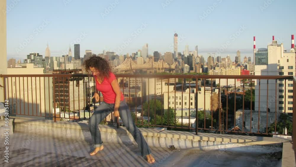 Woman dancing on roof of building, then to daughter joins. Woman dancing on roof of building, then to daughter joins.