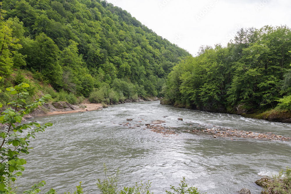 A full-flowing river, a mountainous area, a cloudy day, walks in the bosom of nature, a panorama of the area. A full-flowing river, a mountainous area, a cloudy day, walks in the bosom of nature, a panorama of the area.
