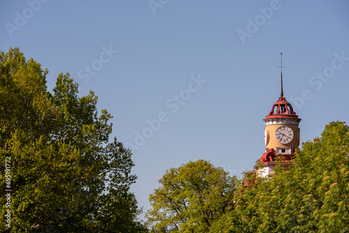 The old bell tower above the green trees