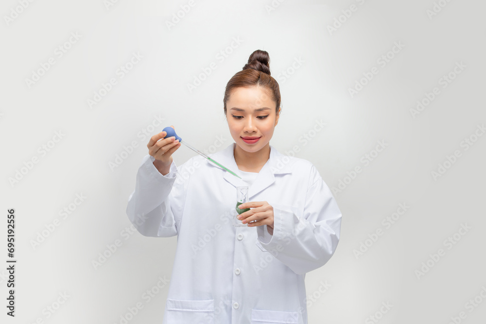 An Asia scientific researcher holding at a liquid solution in a lab. An Asia scientific researcher holding at a liquid solution in a lab.