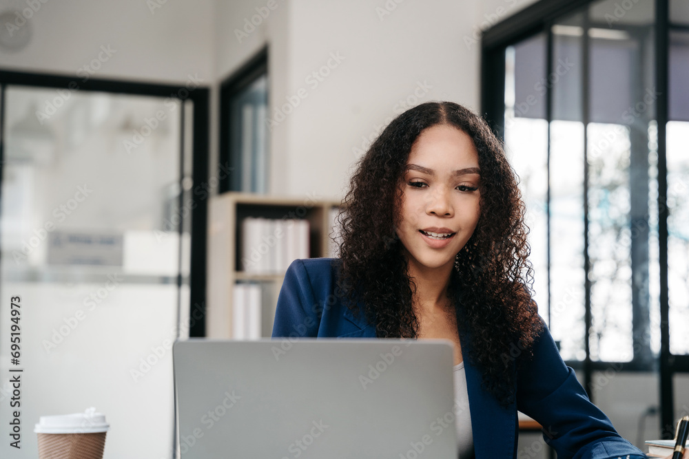 Businesswomen hand working with tablet and laptop computer with documents on office desk in modern office. Businesswomen hand working with tablet and laptop computer with documents on office desk in modern office.