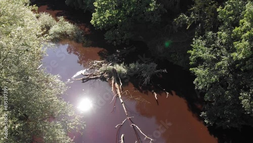 Concrete dam in Stockport river near farming field enables irrigation photo