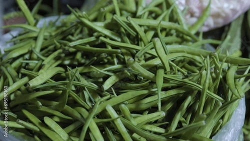 Cyamopsis tetragonoloba,guar or cluster bean at vegetable store for sale at evening photo