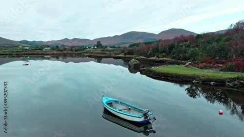 Sneem Ring Of Kerry wild Atlantic way boat on still waters with view of the autumn mountains photo