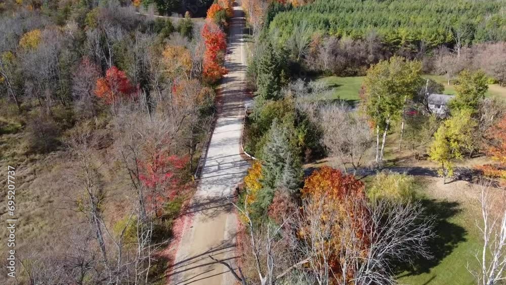 Typical rural landscape scene in autumn. Aerial flying backwards over desert road Typical rural landscape scene in autumn. Aerial flying backwards over desert road