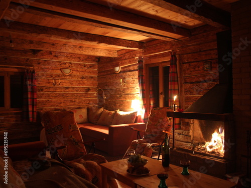 The cozy living room is adorned with various furniture pieces, centered around a warm fireplace, creating a welcoming atmosphere.