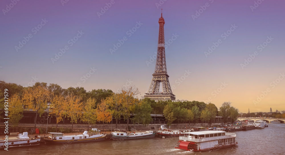 Fototapeta premium Banner of travel in Paris with Eiffel Tower iconic Paris landmark across the River Seine with tourist boat in Autumn tree fall scene at Paris ,France