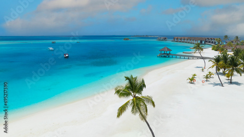Summer palm tree as white sand Tropical beach in maldives paradise scenery seascape with water villas as amazing sea and lagoon beach, Exotic tourism