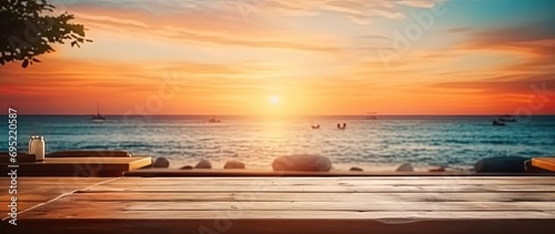 Sunset beach scenery. Captivating image captures serene beauty of sunset at beach. Warm hues of orange and blue dominate sky as sun begins to dip below horizon casting soft glow over tranquil sea