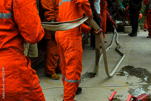 stcw fire fighting prevention training, firemen doing hose technique exersises, maritime courses