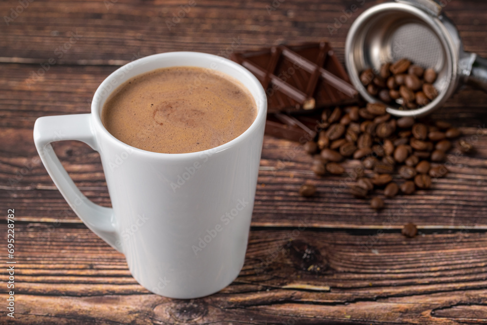 Chocolate coffee in white porcelain cup on wooden table Chocolate coffee in white porcelain cup on wooden table