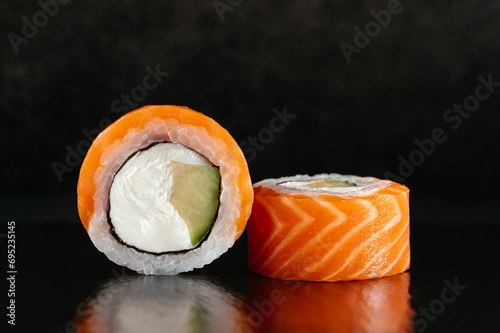 Philadelphia Japanese sushi roll with salmon on a dark backgroun photo