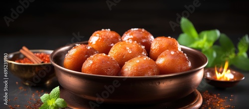 Indian festival sweets like gulab jamun are commonly eaten during Diwali, Dussehra, Deepavali, Pongal, Durga Pooja, Holi, Ganesh Chaturthi, Navratri, and Bengali festivals in Delhi. photo