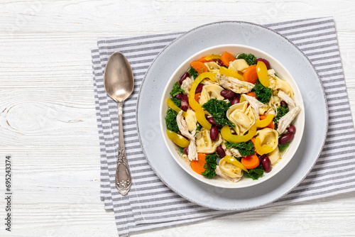 chicken minestrone soup with tortelloni in bowl
