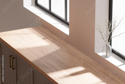 A bright beige-toned kitchen interior with sunlight 
coming through the window.