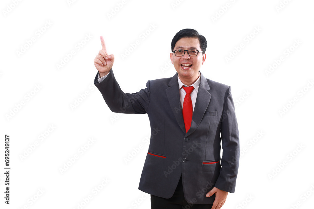Wow excited asian businessman standing while pointing sideways on empty space and looking at the camera Wow excited asian businessman standing while pointing sideways on empty space and looking at the camera