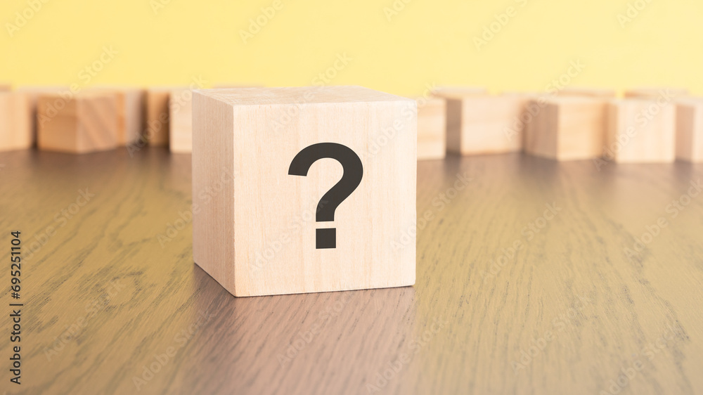 question mark written on wooden cube lying on table, business and education concept. close-up cubes question mark written on wooden cube lying on table, business and education concept. close-up cubes