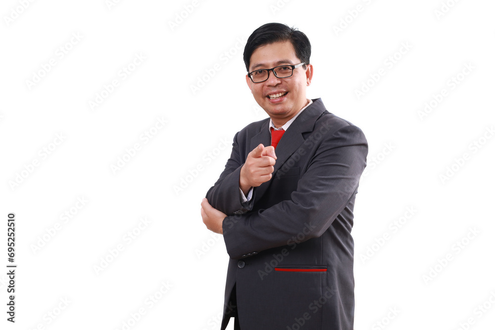 Optimistic asian businessman standing while pointing at you. Isolated on white background
