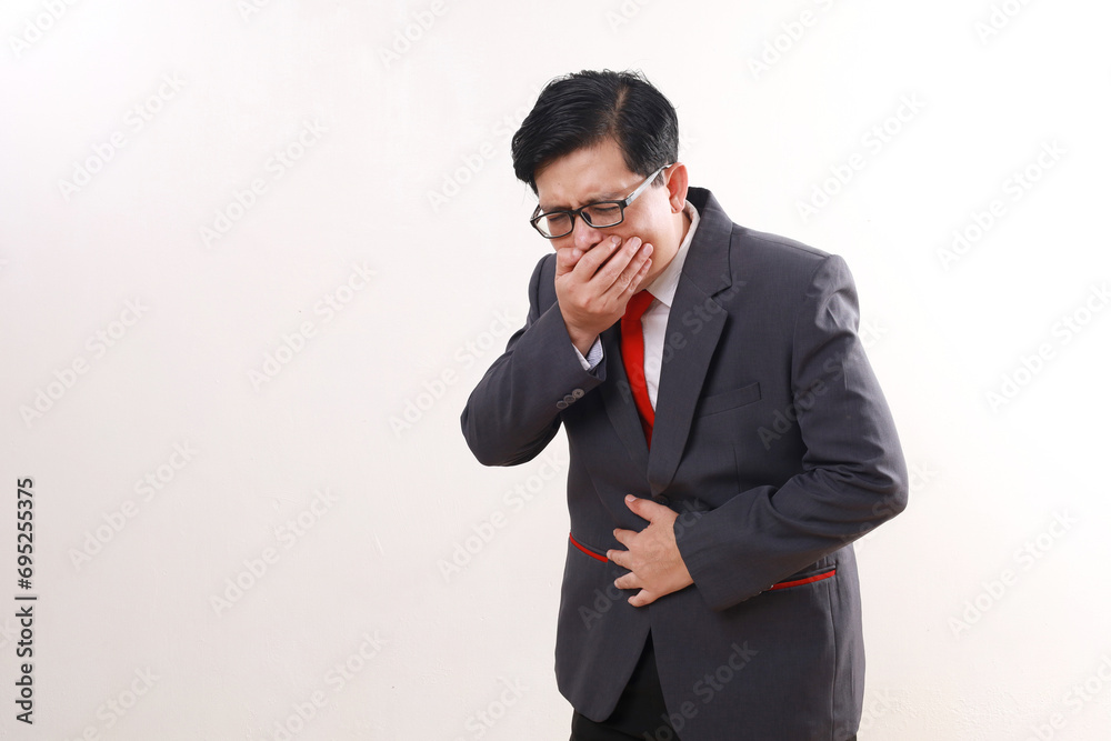 Asian businessman covering mouth and holding belly. nauseous concept Asian businessman covering mouth and holding belly. nauseous concept