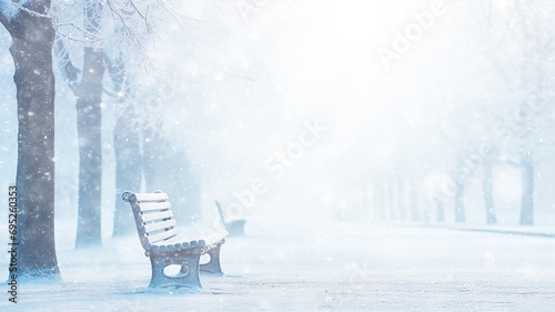 snowfall winter landscape, park bench, abstract background copy space, blurred light white snow falling, christmas postcard view photo
