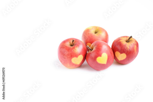 Fresh red apples with heart shape on it isolated on white background, healthy eating, health, holiday concept, copy space