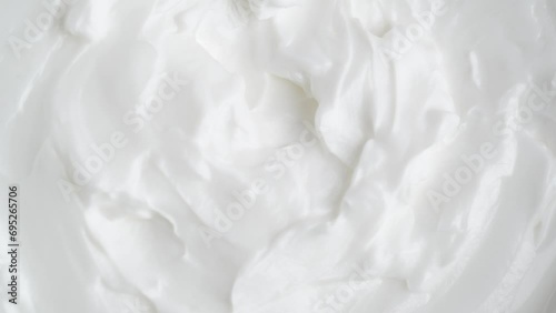 White smooth creamy moisturizing face cream texture, rotation, macro. Top view photo