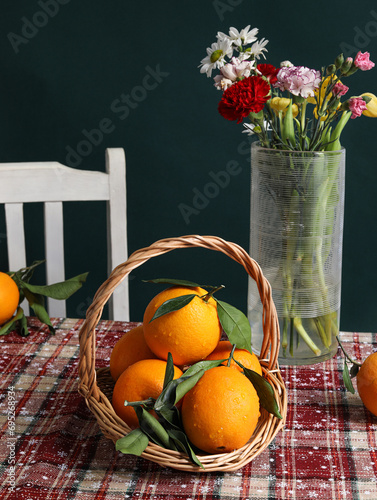 Oranges and flowers on the table