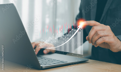 Businessman hand with graph economic growth success chart on virtual screen. Investor data analysis for planning in strategy of stock market fund.