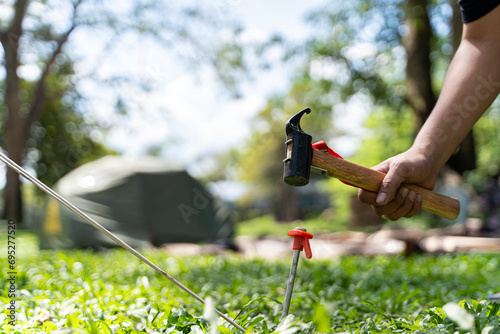 Fotografija Man setting up camping tent outdoors, closeup