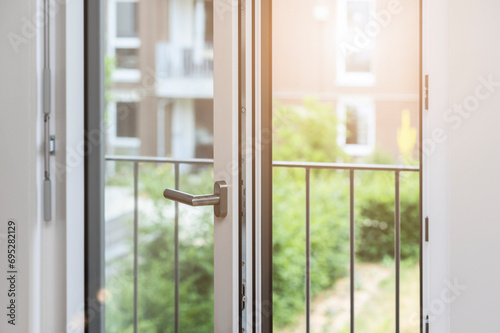 Open Window Door with French Balcony on Room of Apartment Building Inside. Modern Large Windows.