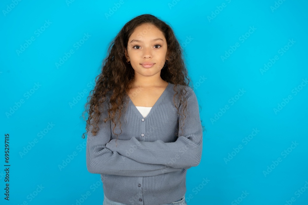 Dreamy rest relaxed Beautiful teen gil wearing casaul clothes over blue background crossing arms, Dreamy rest relaxed Beautiful teen gil wearing casaul clothes over blue background crossing arms,