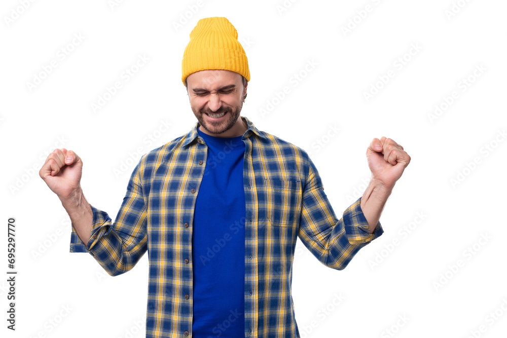 handsome young hipster man in cap and shirt gesturing actively on white background with copy space