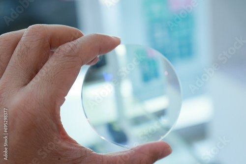 close up of hand holding a magnifying glass photo