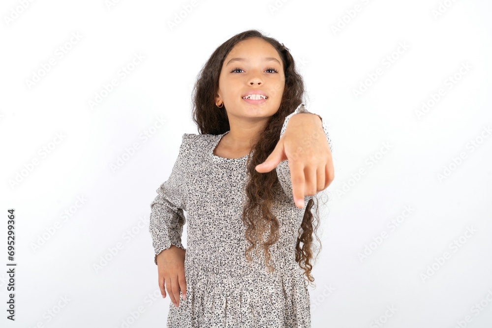 Beautiful teen gil wearing gray dress over white background pointing at camera with a satisfied, confident, friendly smile, choosing you Beautiful teen gil wearing gray dress over white background pointing at camera with a satisfied, confident, friendly smile, choosing you