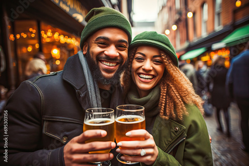 Happy couple toasting with beer on St. Patrick's Day photo