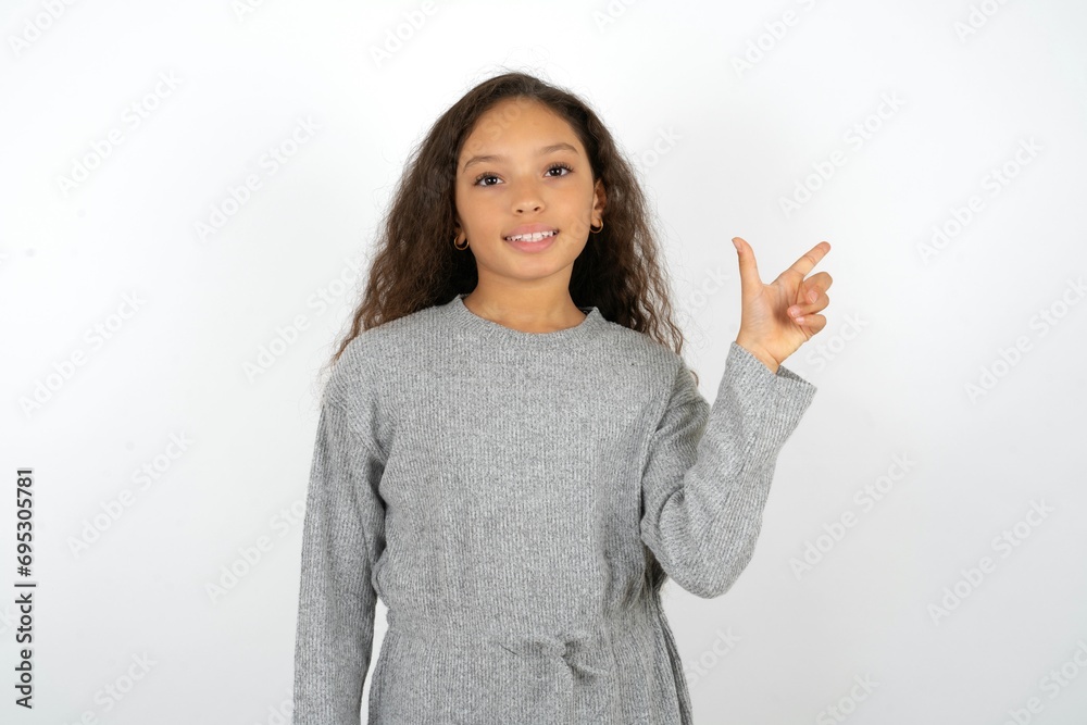 Beautiful teenager girl pointing up with fingers number eight in Chinese sign language Ba. Beautiful teenager girl pointing up with fingers number eight in Chinese sign language Ba.