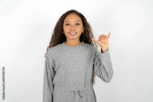 Beautiful teenager girl  showing up number six Liu with fingers gesture in sign Chinese language photo