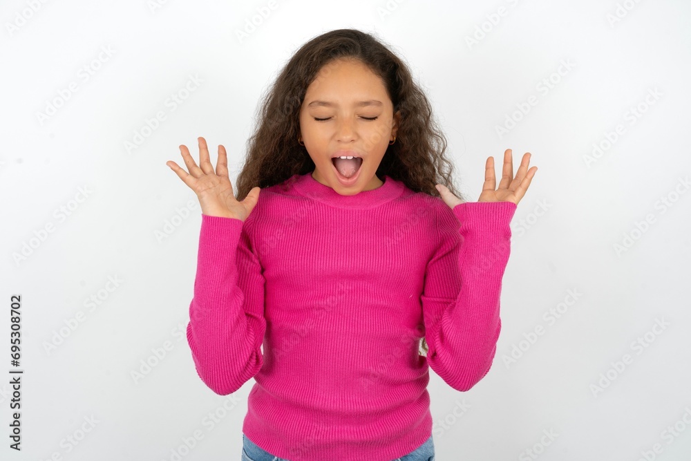 Crazy outraged Young beautiful teen girl screams loudly and gestures angrily yells furiously. Negative human emotions feelings concept