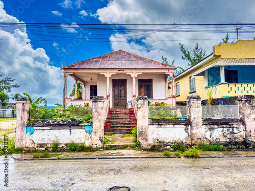 Bridgetown, Barbados -  frontal view of an old colorful abandoned city villa at Bay Street in Bridgetown  photo