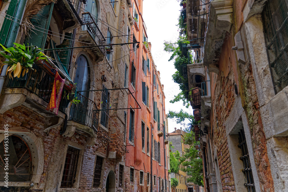 Old town of City of Venice with narrow alley on a blue cloudy summer day. Photo taken August 6th, 2023, Venice, Italy.