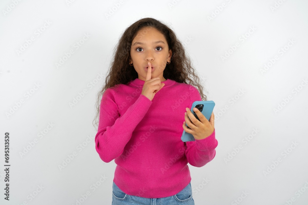 Young beautiful teen girl holding modern gadget ask not tell secrets Young beautiful teen girl holding modern gadget ask not tell secrets