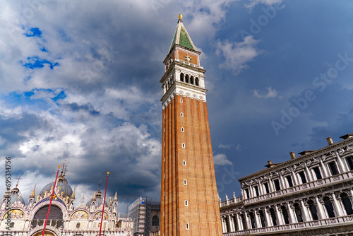 Looking up brick wall church tower of cathedral at Piazza san Marco at City of Venice on a sunny summer day. Photo taken August the 6th, 2023, Venice, Italy.