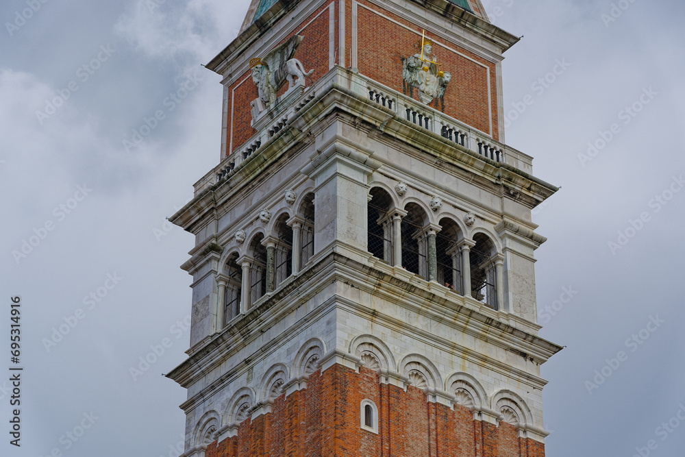 Looking up church tower at Piazza san Marco at City of Venice on a cloudy sunny summer day. Photo taken August the 6th, 2023, Venice, Italy. Looking up church tower at Piazza san Marco at City of Venice on a cloudy sunny summer day. Photo taken August the 6th, 2023, Venice, Italy.