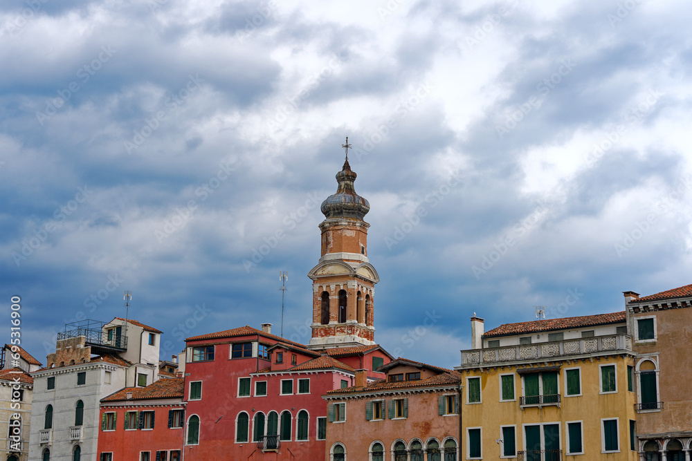Scenic view of skyline with church tower of church named San Bartolomeo at the old medieval town of Venice on a cloudy summer afternoon. Photo taken August 6th, 2023, Venice, Italy.